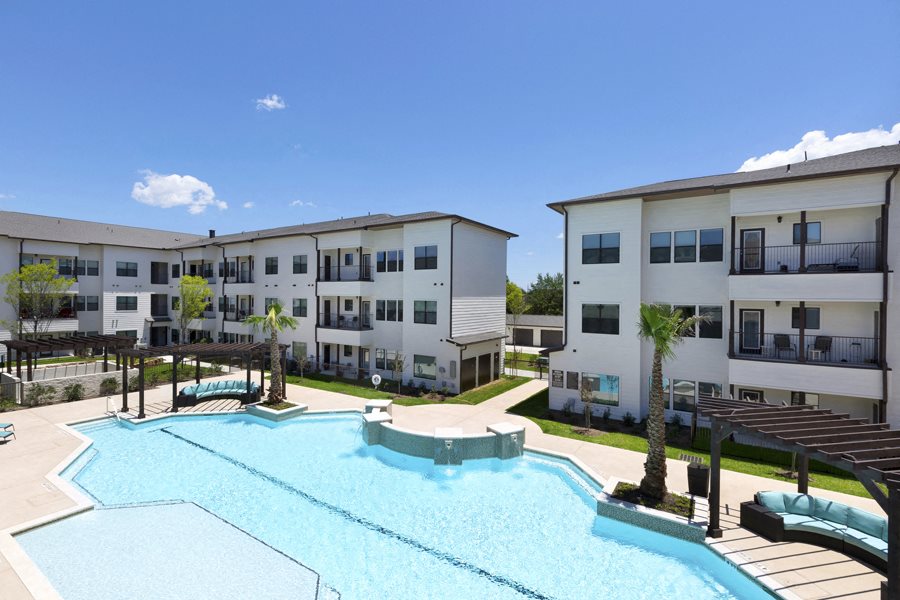 a resort-style pool and lounge area at a senior apartment community